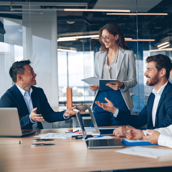 team laughing and working together at a table